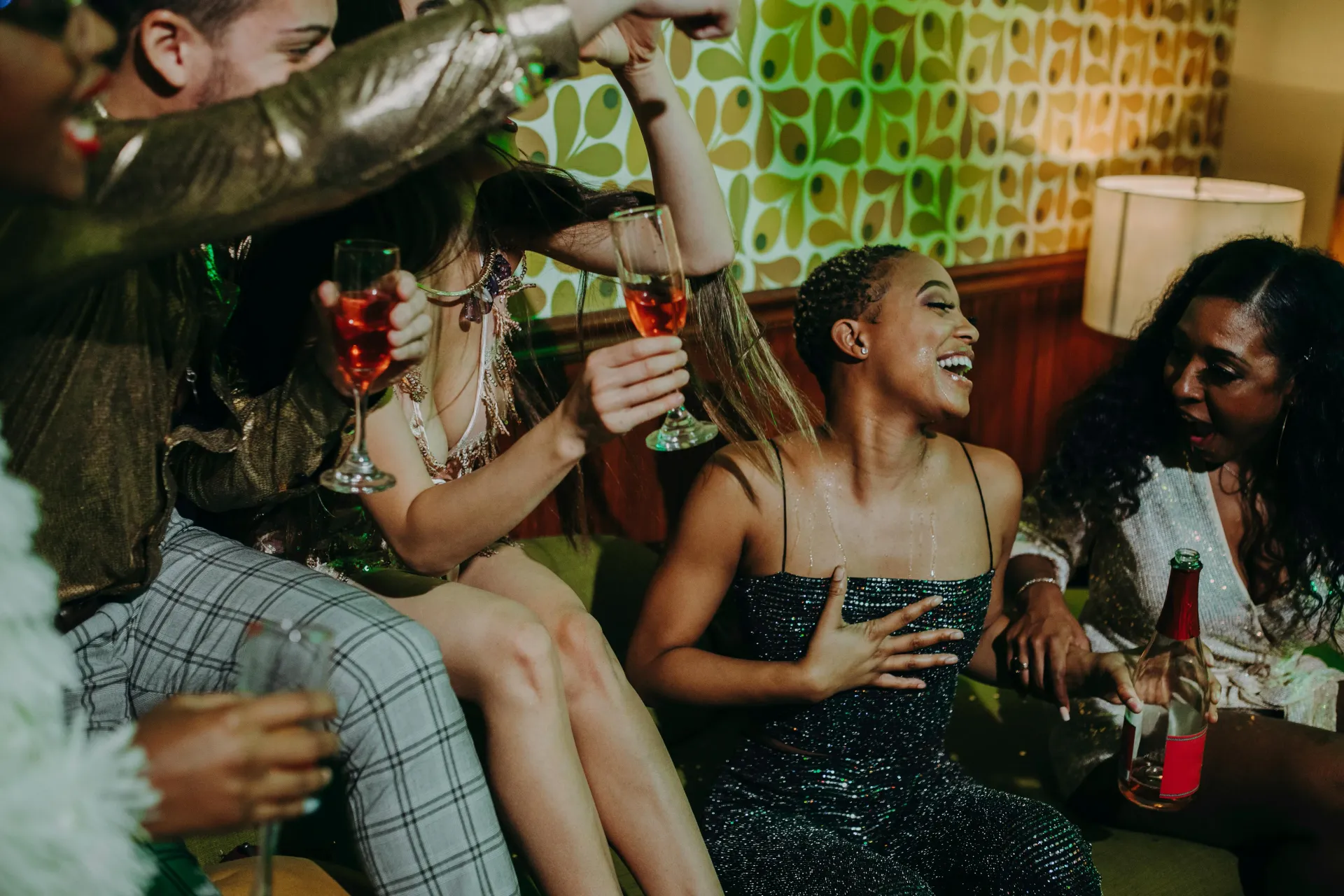 Group of people enoying alcoholic drinks at a house party.