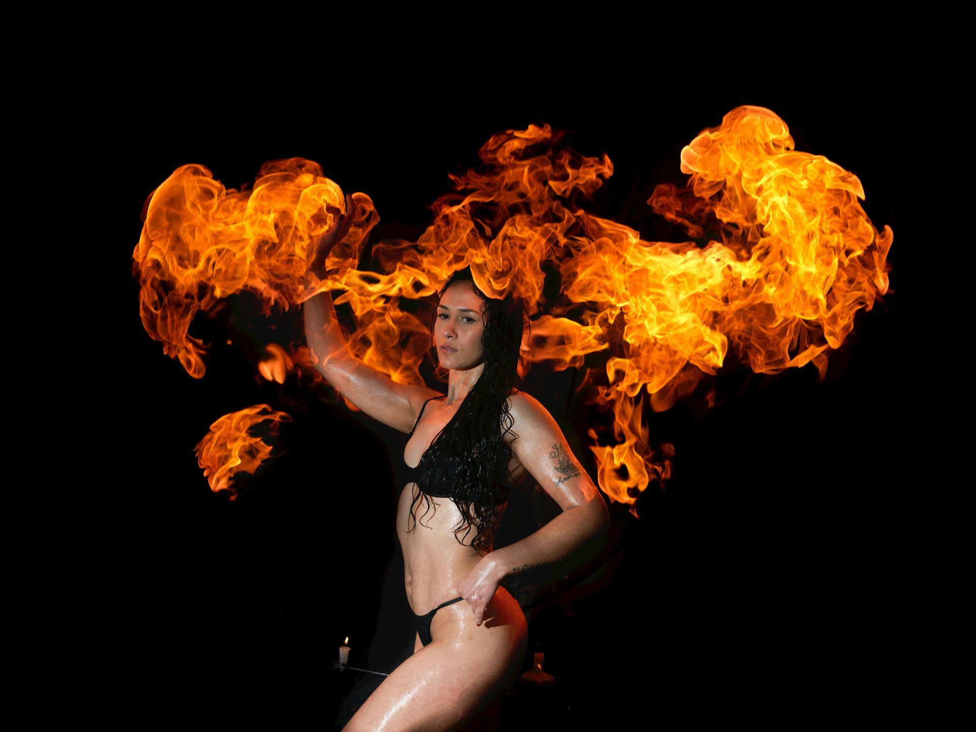 Fire dancer performing with big fire flames.