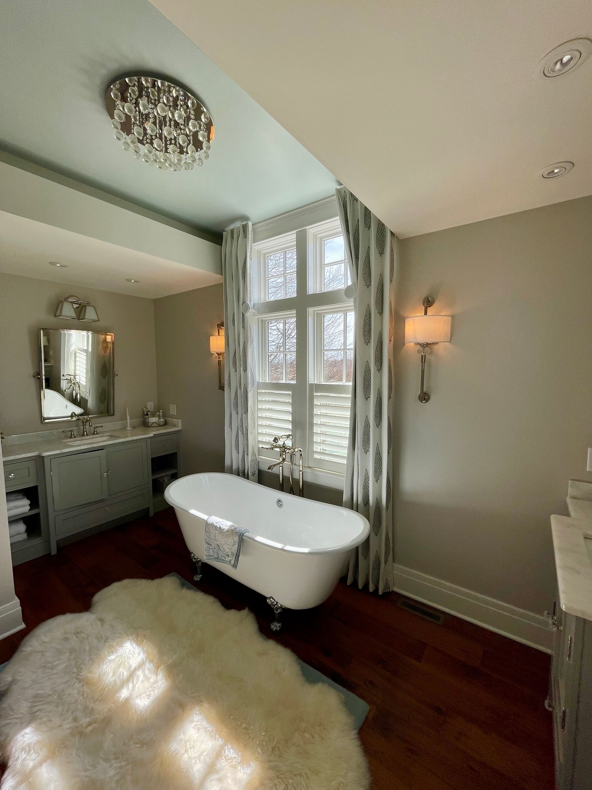 Dining room with long wooden table, chairs, and a rectangular chandelier.