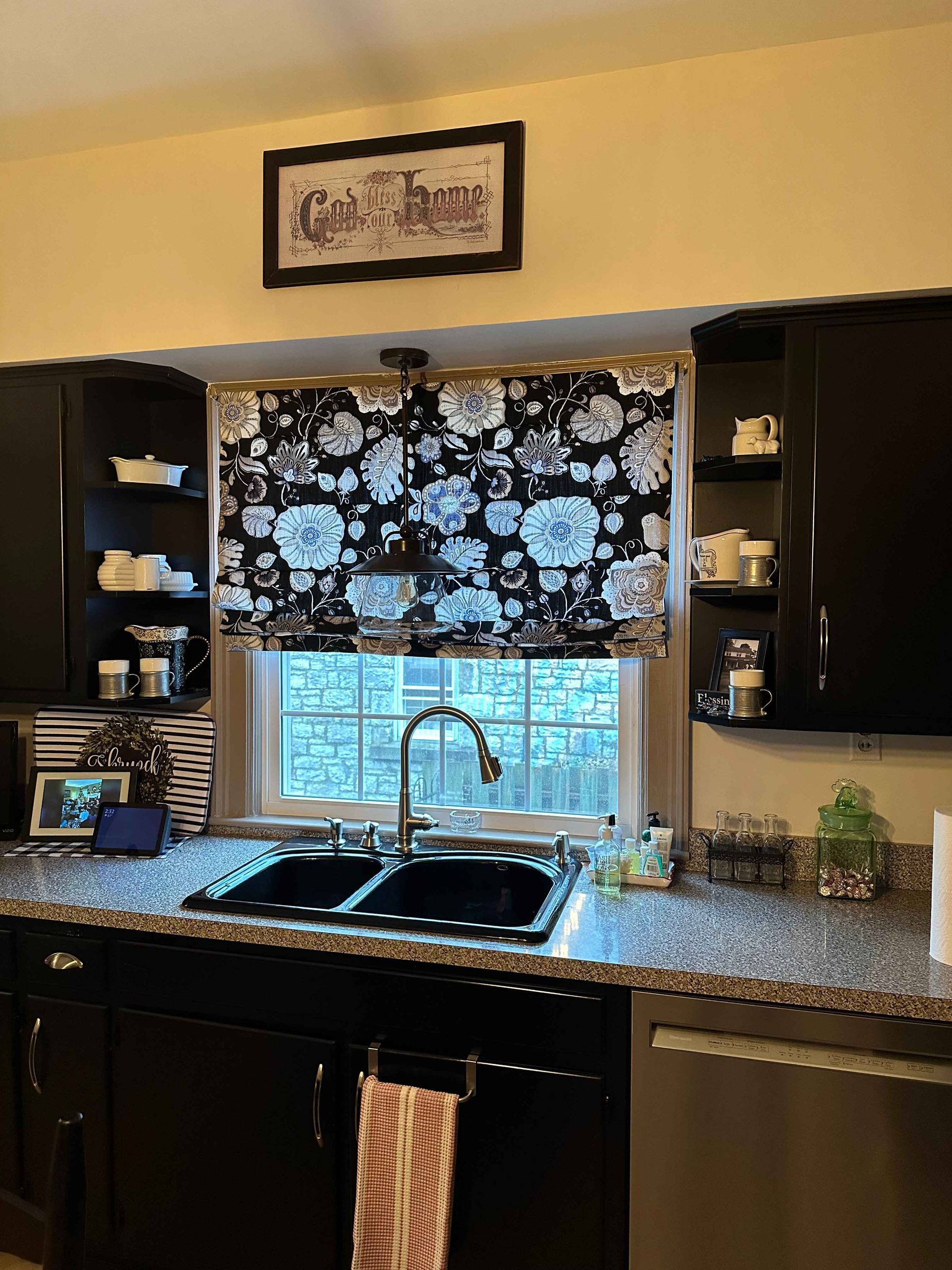 Three windows with burgundy valances overlooking a deck with seating.