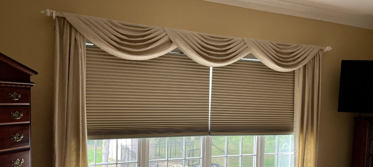 Window with draped valance, curtains, and blinds. Beige, window open, interior.
