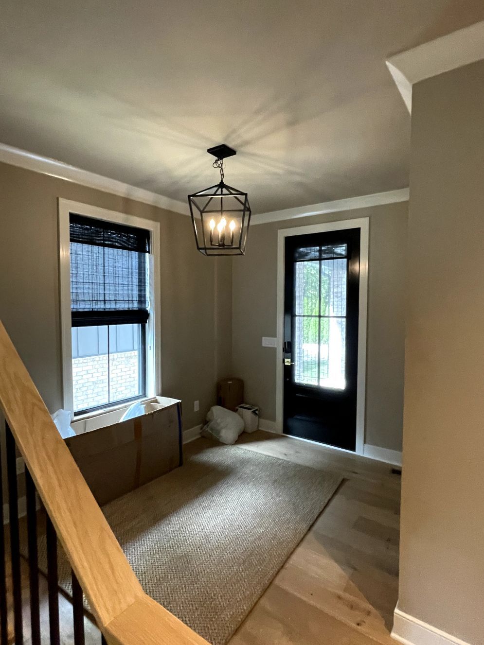 An entery way has black woven wood shades on the windows - Window Fashions on Wheels.