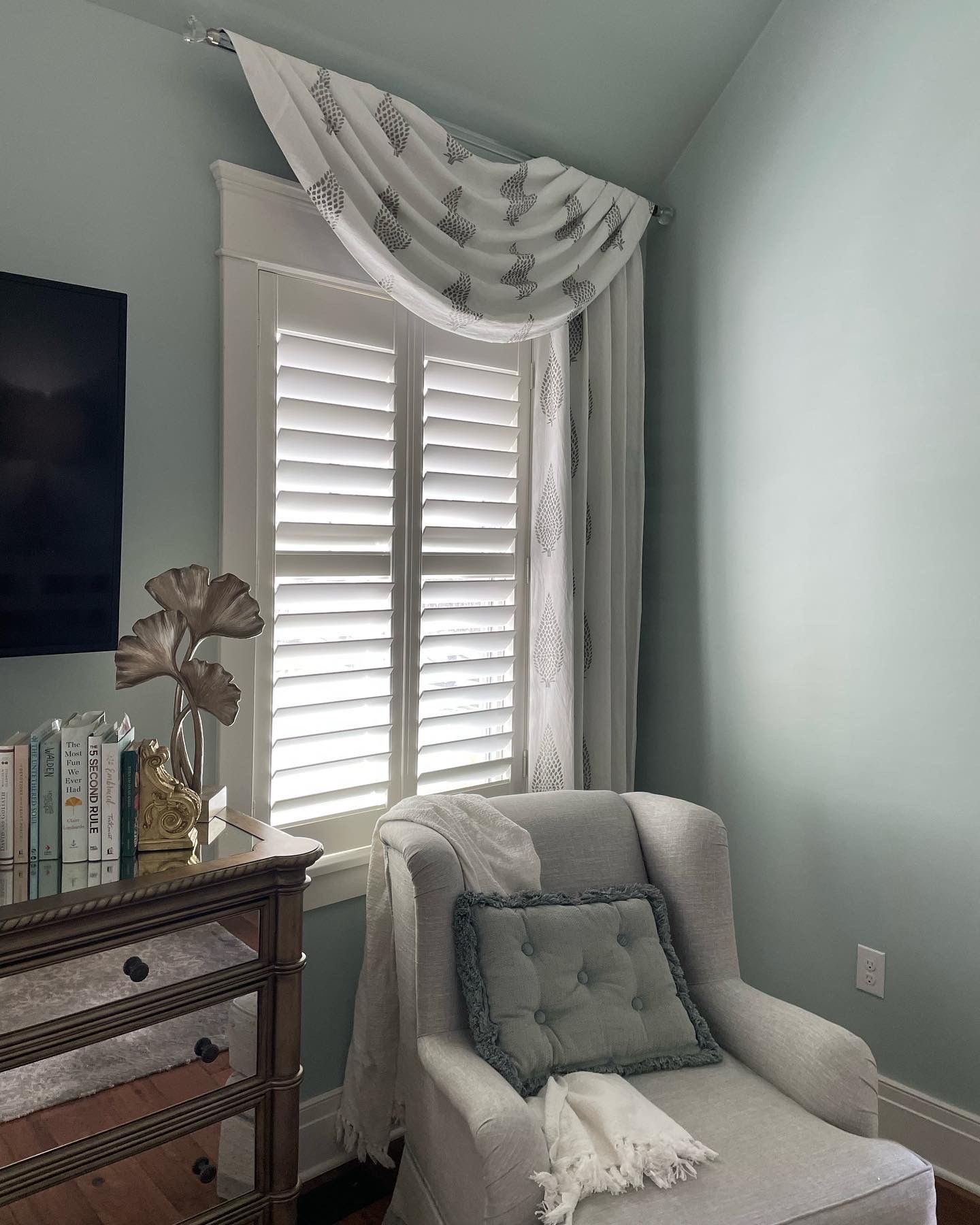 White interior shutters make a reading corner extra cozy - Window Fashions on Wheels.