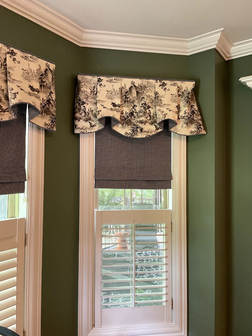 Windows in a dining room have layered window treatments: valance, roman shades, and shutters - window fashions on wheels, ky