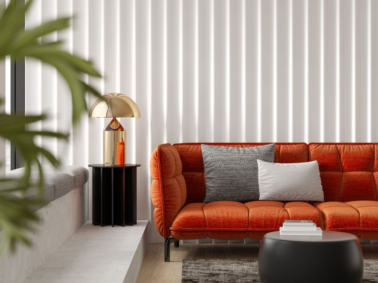 Orange sofa with gray pillows, side table with gold lamp, in a room with white vertical striped wall.