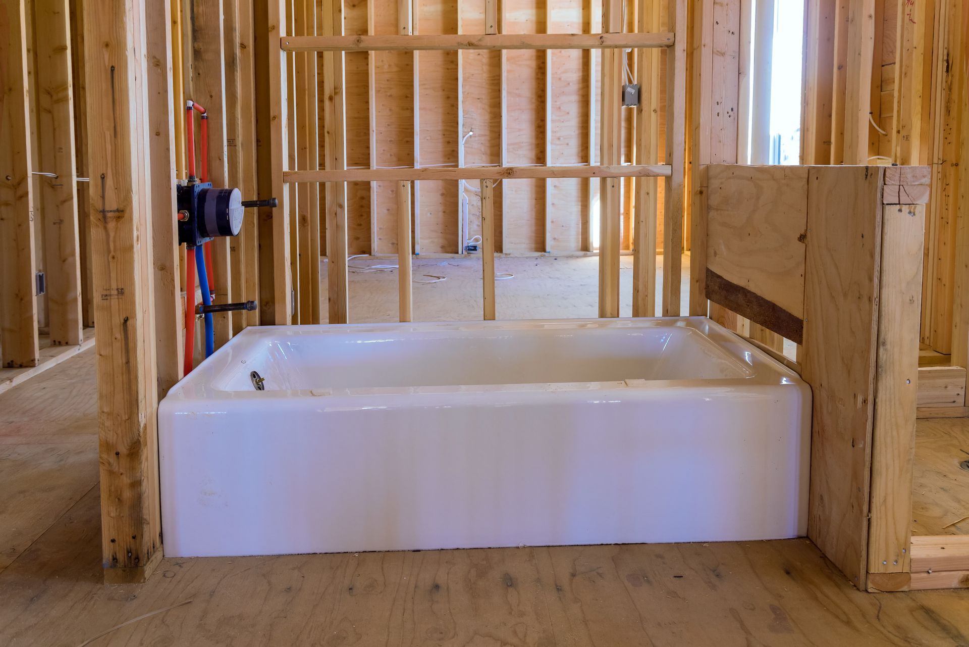 A bathtub is sitting in a room under construction.