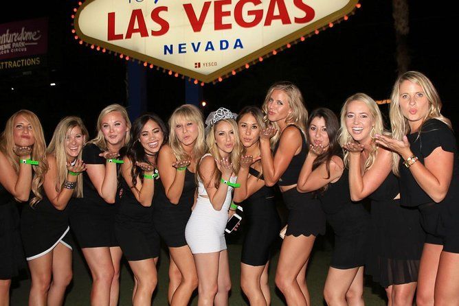 A group of women standing in front of a las vegas sign