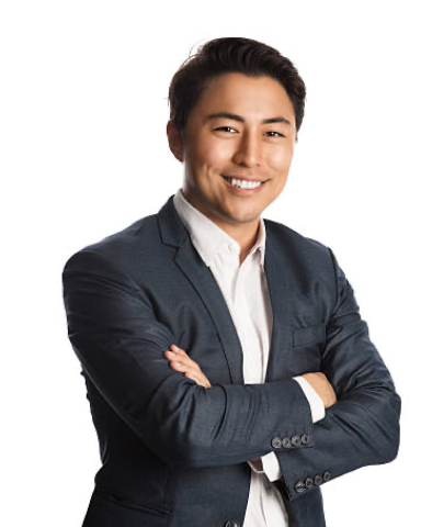 A man in a suit and tie is smiling for the camera