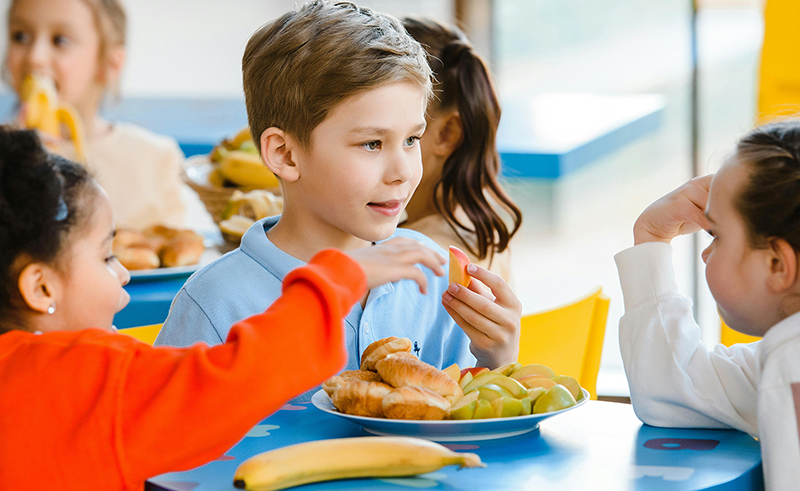Young students eating lunch in a cafeteria