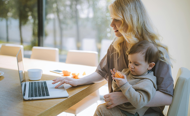 Mother and young child looking at a computer