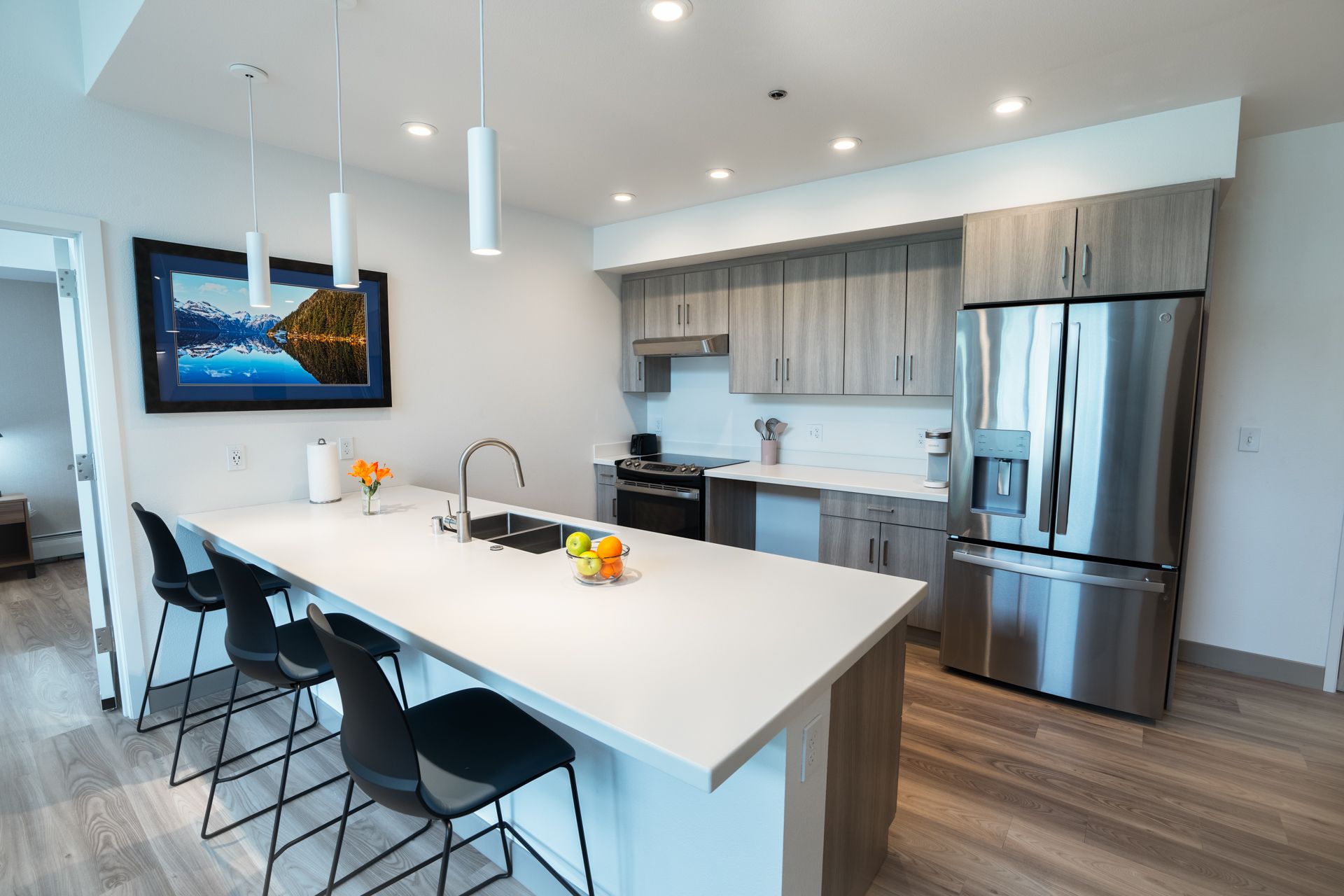 A kitchen with a large island and stainless steel appliances.