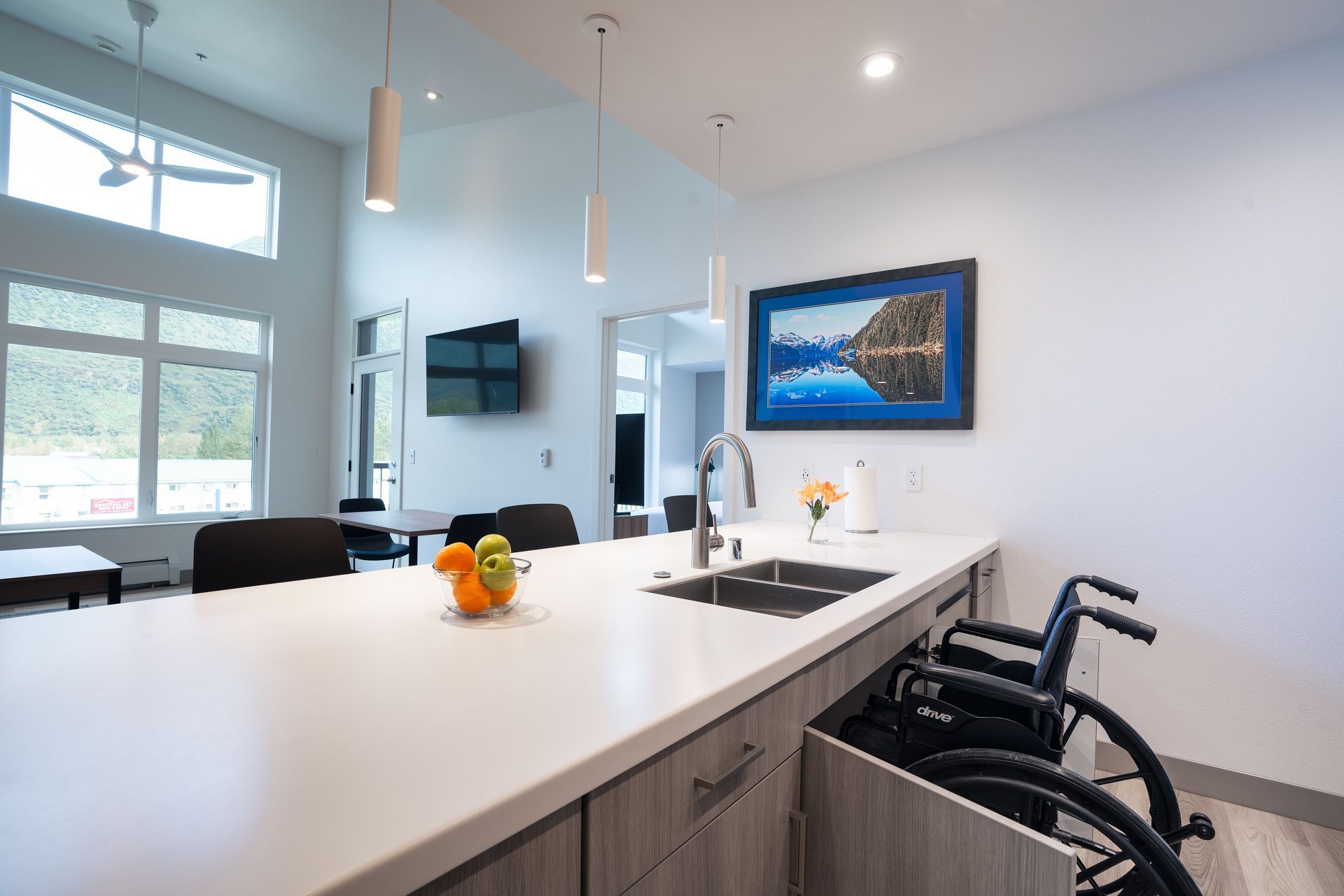Kitchen with accessible sink, and fruit on countertop.