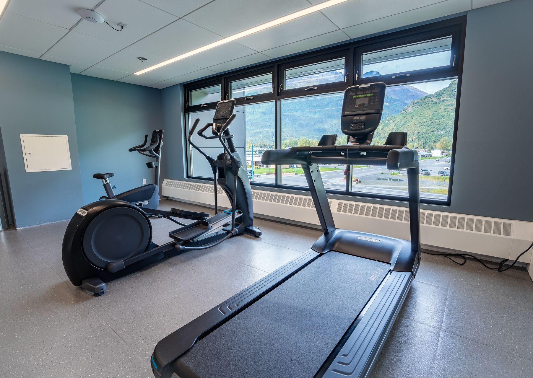 There are two treadmills and an elliptical in the gym.