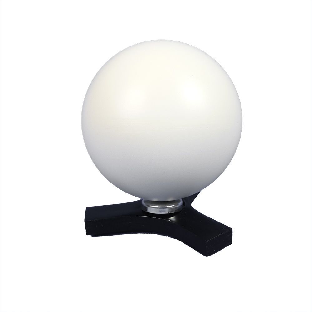 A black lamp with a white ball on top of it