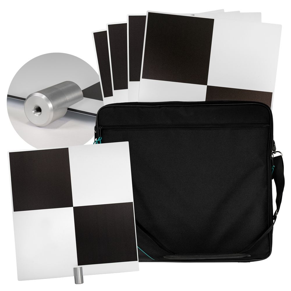 A black and white checkered sign is sitting on top of an orange and white traffic cone.