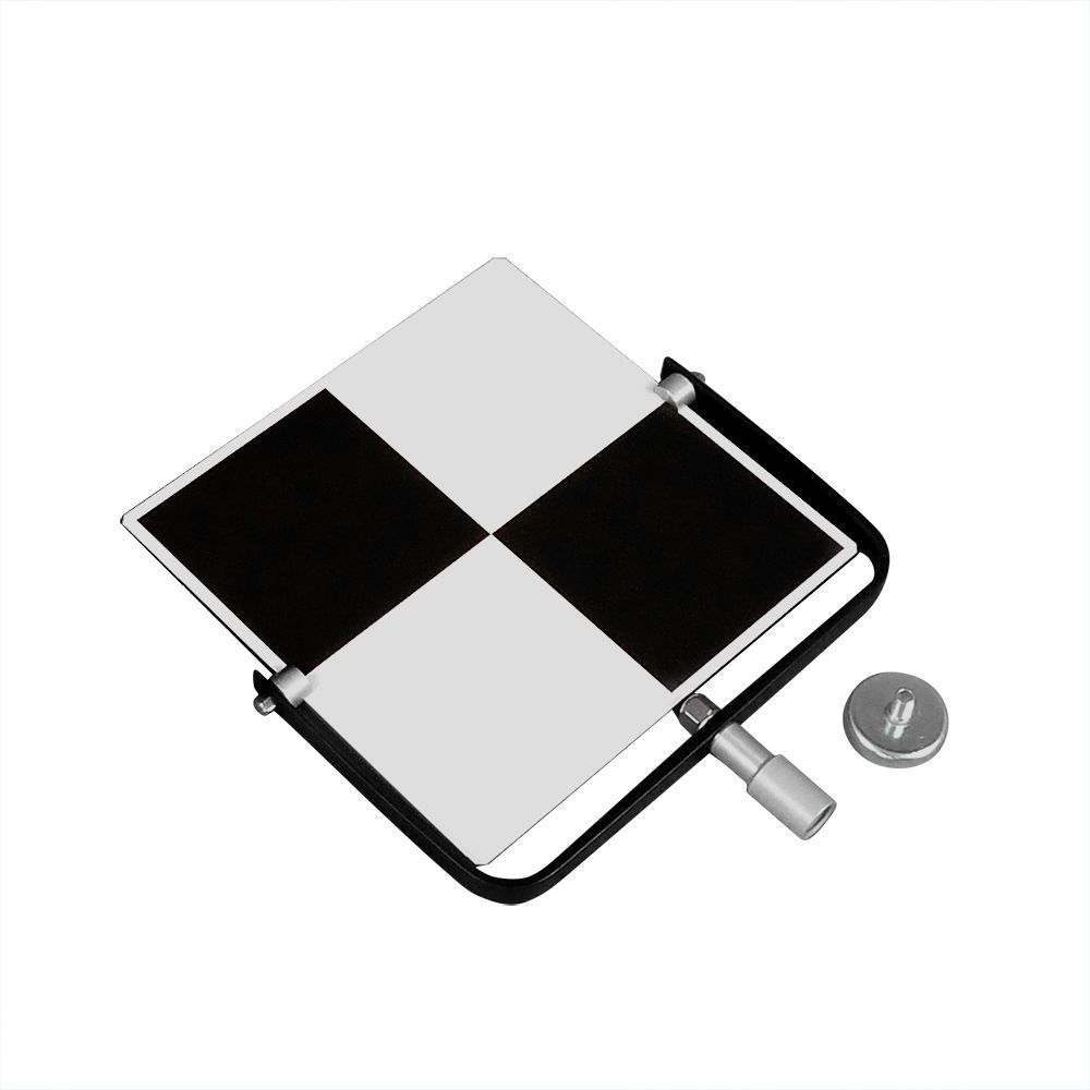 A black and white checkered sign is sitting on top of a table.