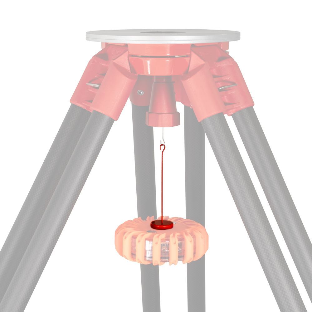 A tripod with a red object hanging from it.