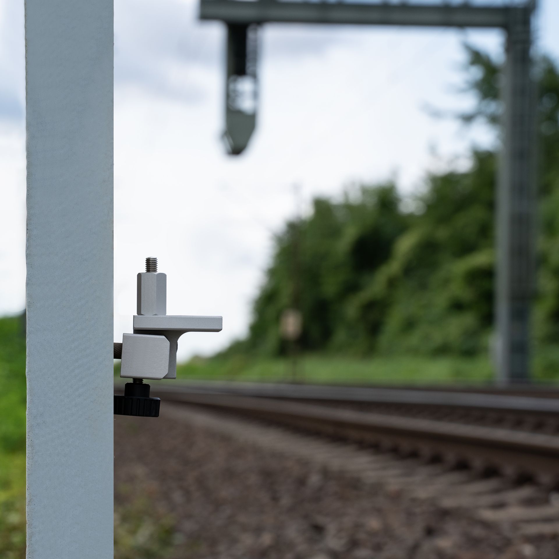 A white object is attached to a pole with measurements on it