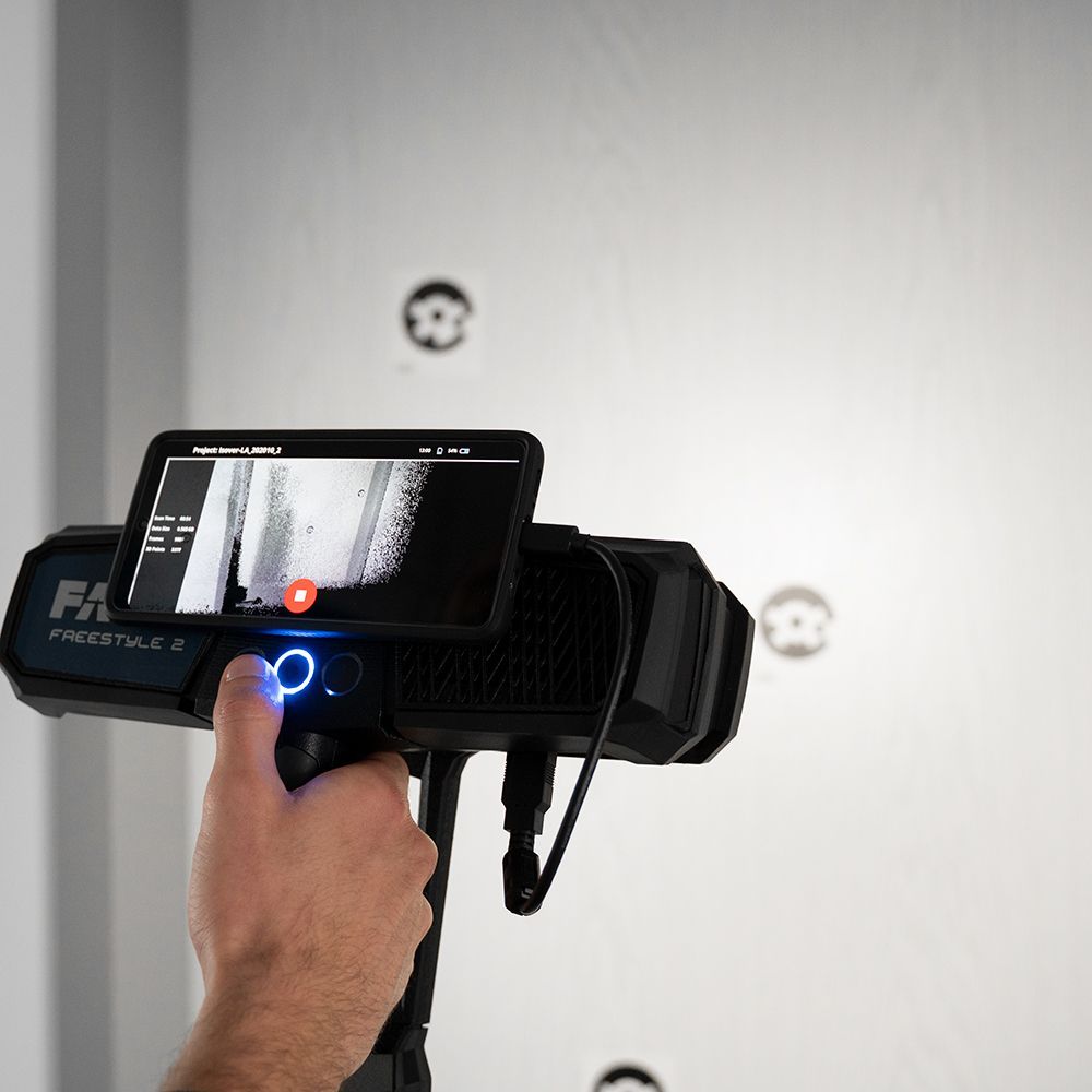 A person is holding a cell phone with a picture of a door on the screen