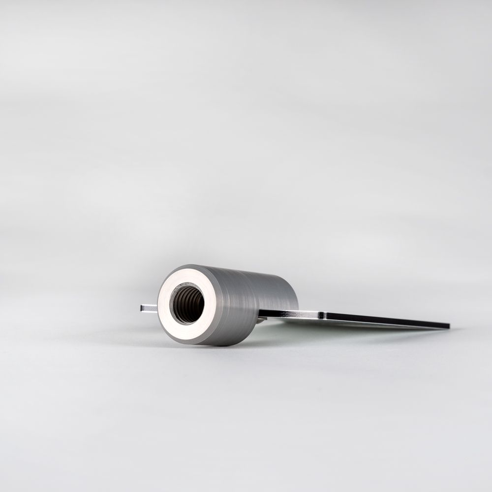 A tripod with a checkered flag on top of it.