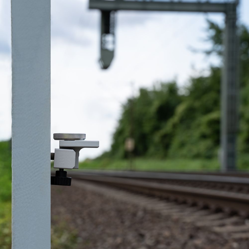 A white ball is attached to a pole with measurements on it