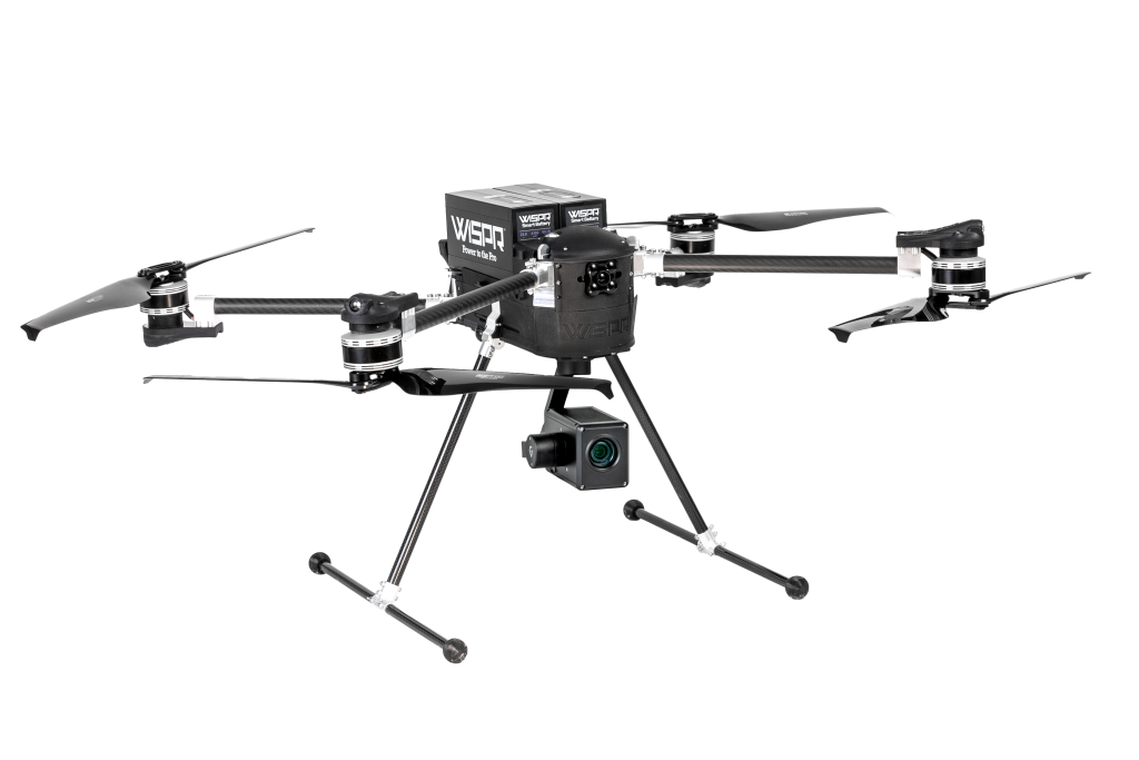 A black drone is sitting on a white surface.