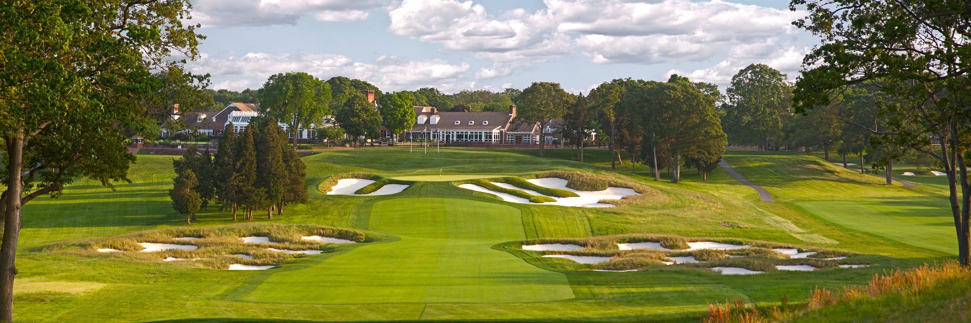 A golf course with a house in the background