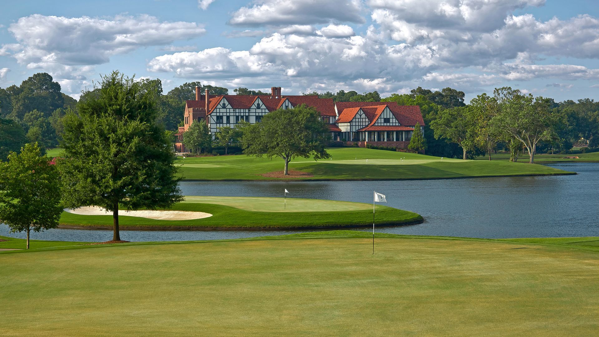A golf course with a large house in the background
