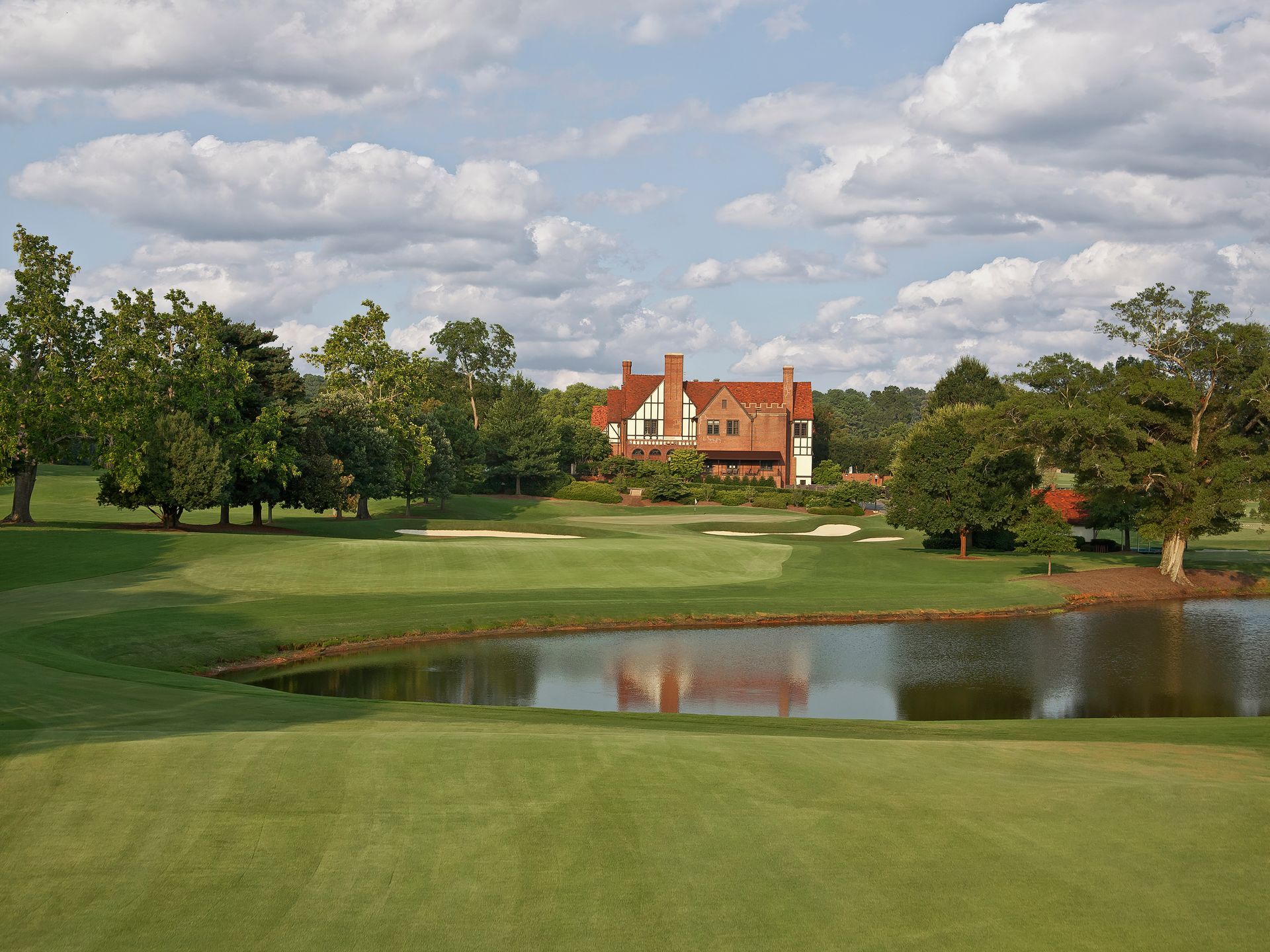 A golf course with a large house in the background