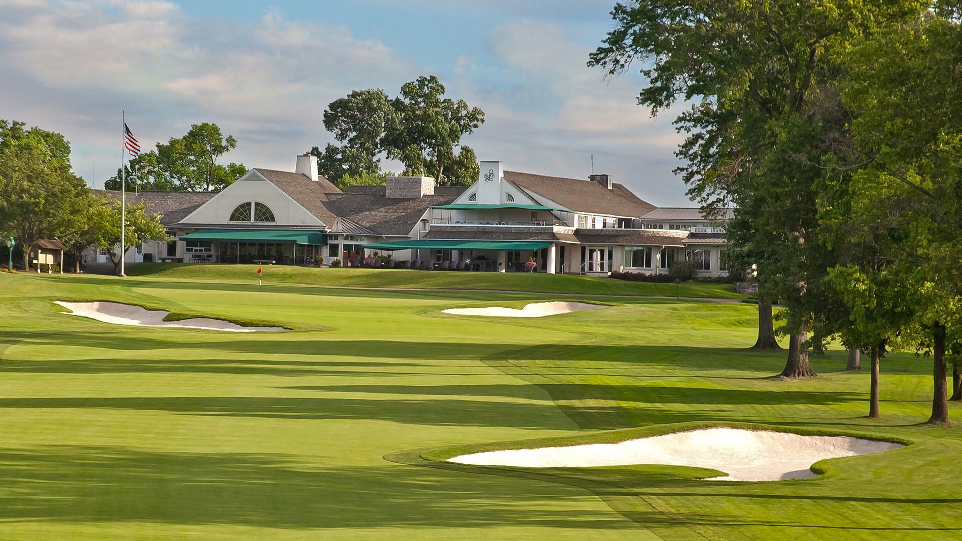 A golf course with a clubhouse in the background
