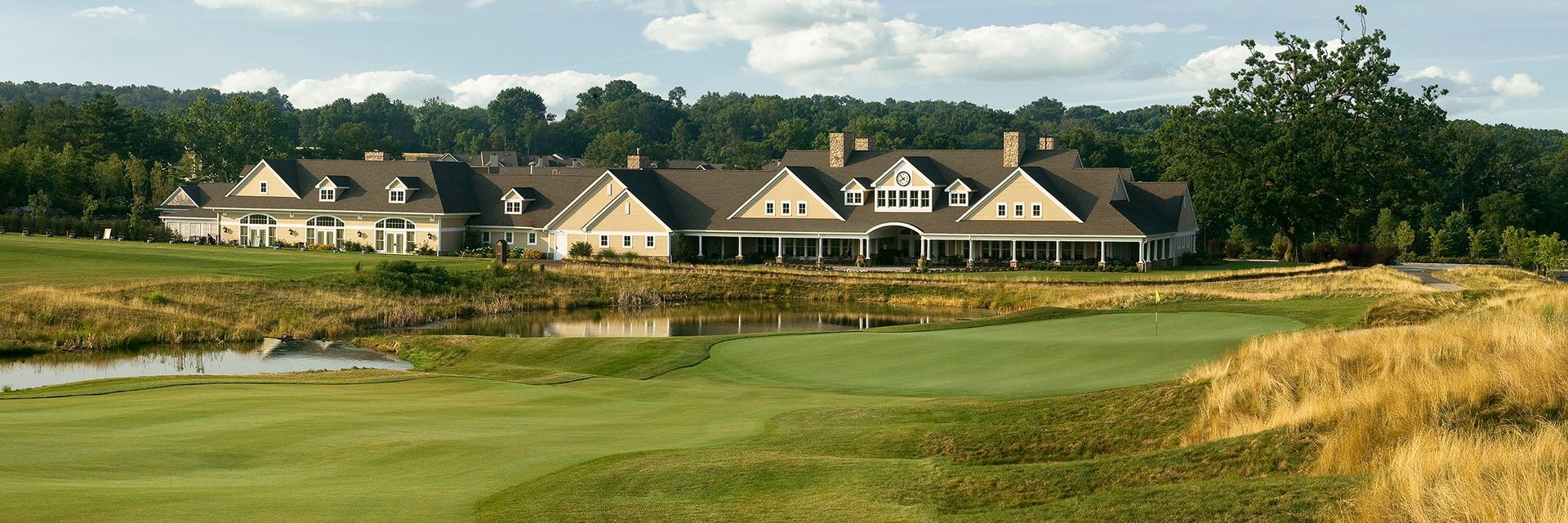 A golf course with a large house in the background