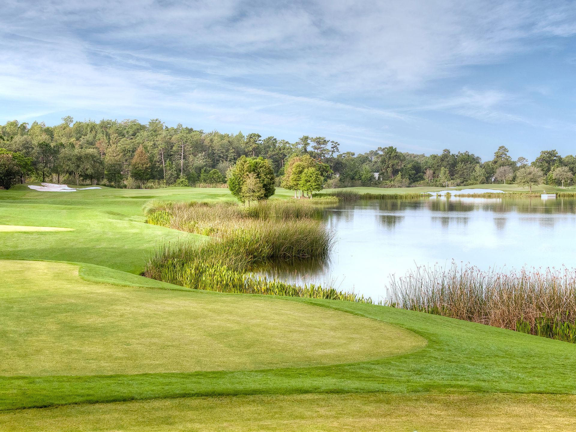 A golf course with a lake in the middle of it.