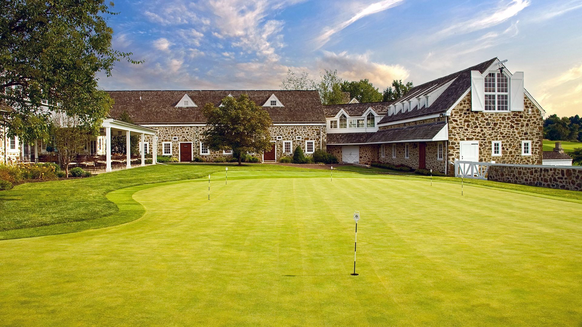 A large house with a large lawn in front of it.