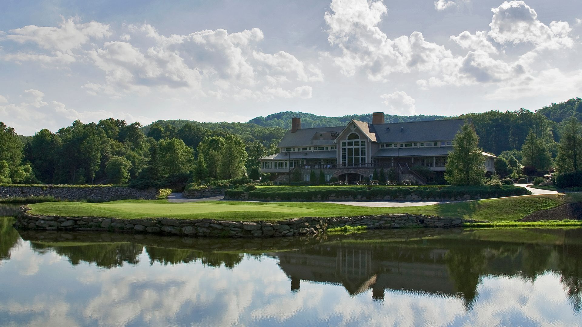 A large house is reflected in a body of water