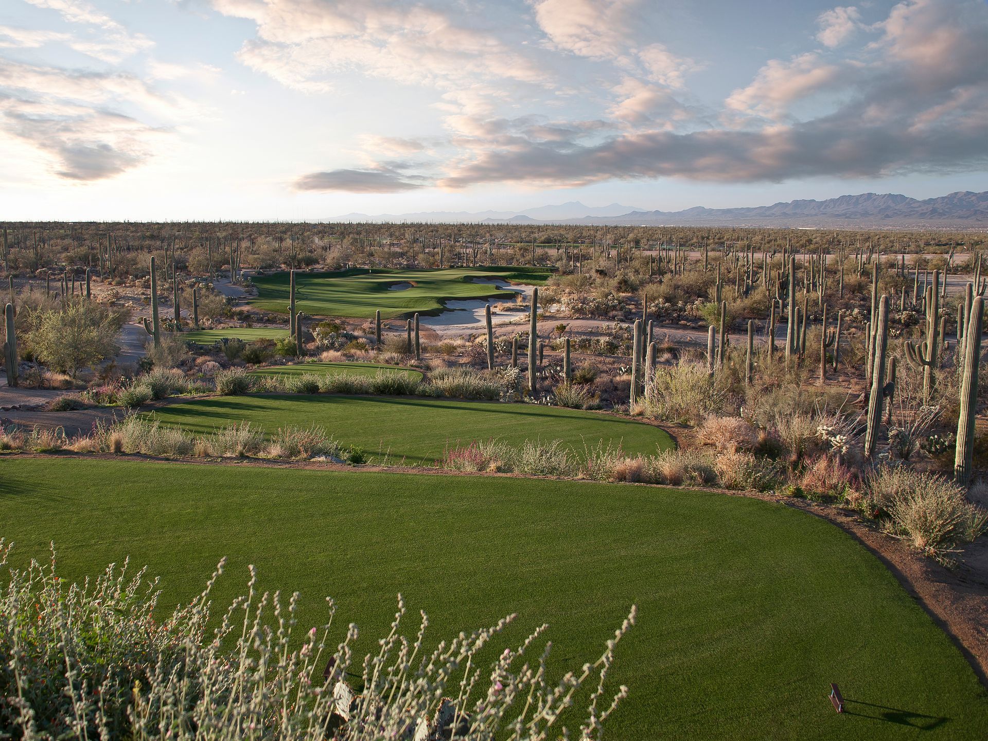 An aerial view of a golf course in the desert.