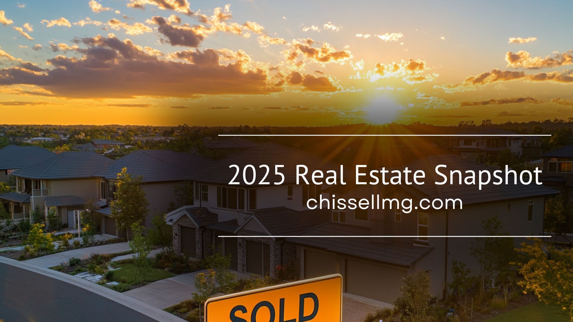 A sunset over a residential area with a sold sign in front of a house.