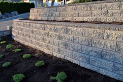 A brick wall with a planter in the middle of it