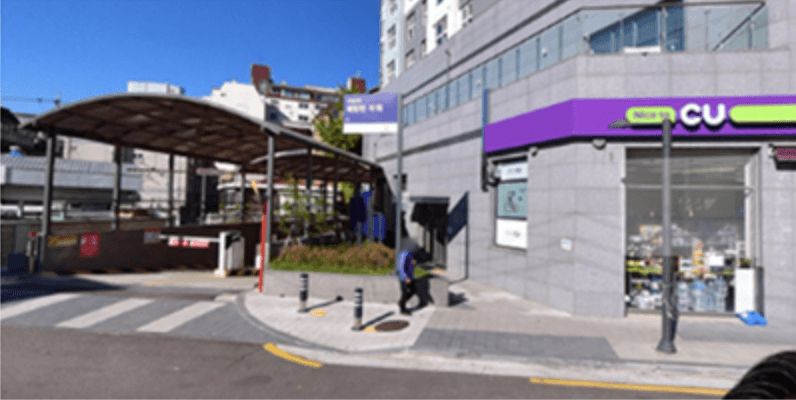 Exterior of a CU convenience store with a parking garage entrance in Korea.