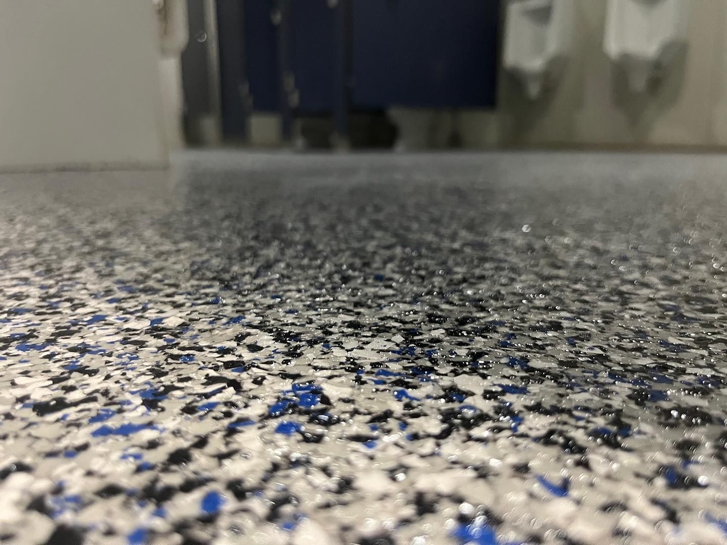 close up of floor with concrete coating in mixed blue, white and black color