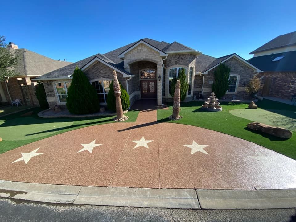 aerial view of residential house with beautiful landscape and coated concrete pavement against blue sky
