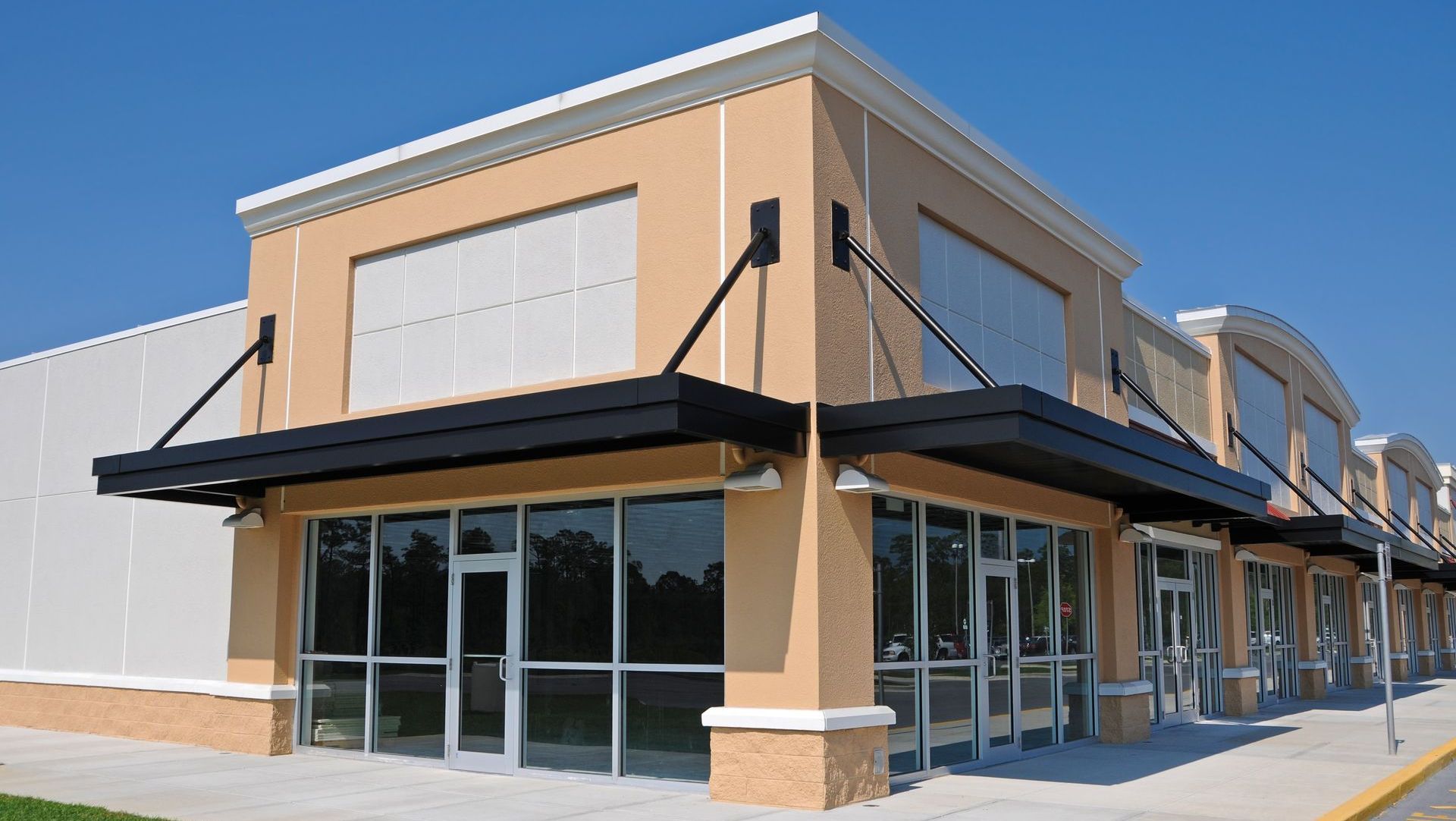 A large building with a lot of windows and a canopy