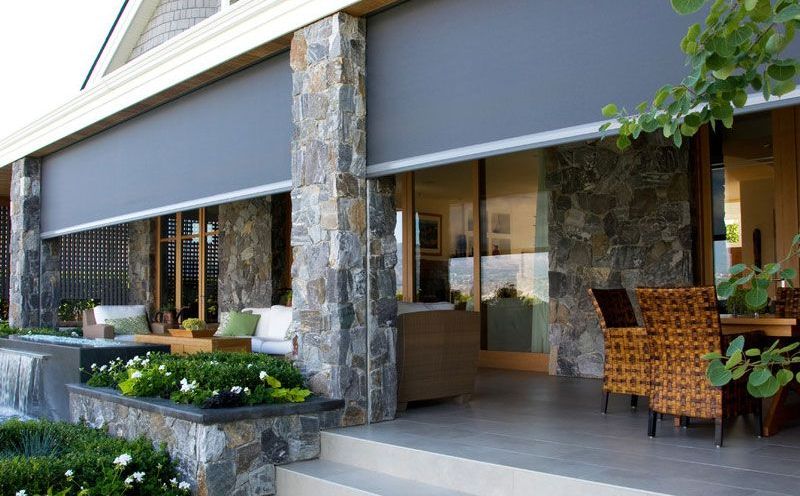 A house with a patio with a lot of chairs and a table.