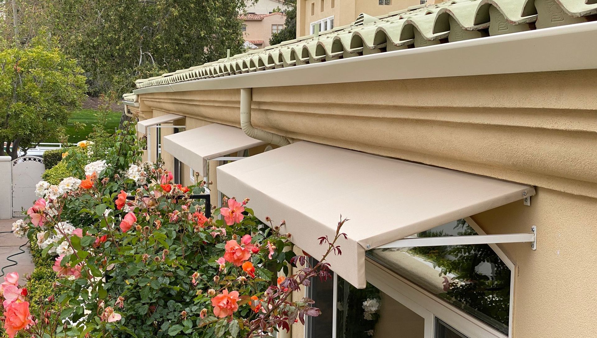 A row of awnings are hanging from the side of a building.