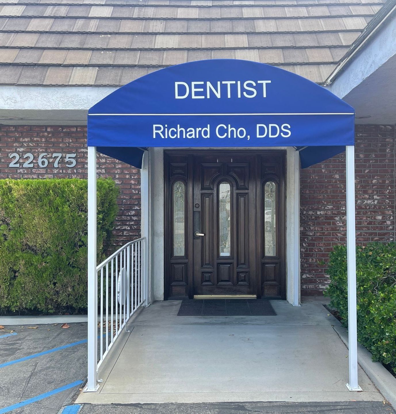 A blue awning over the entrance to a dentist office