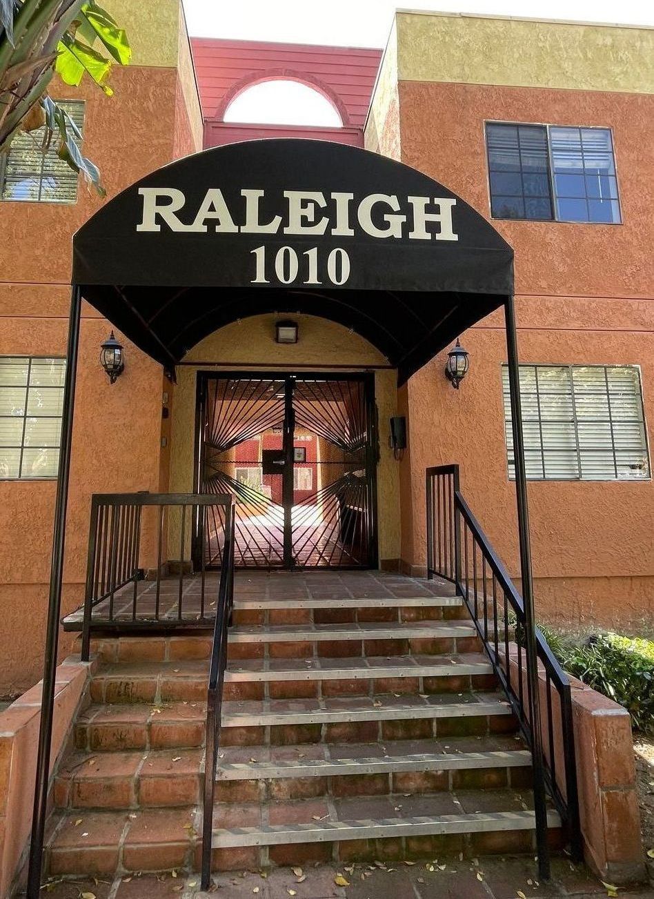 A building with a black awning that says raleigh 1010