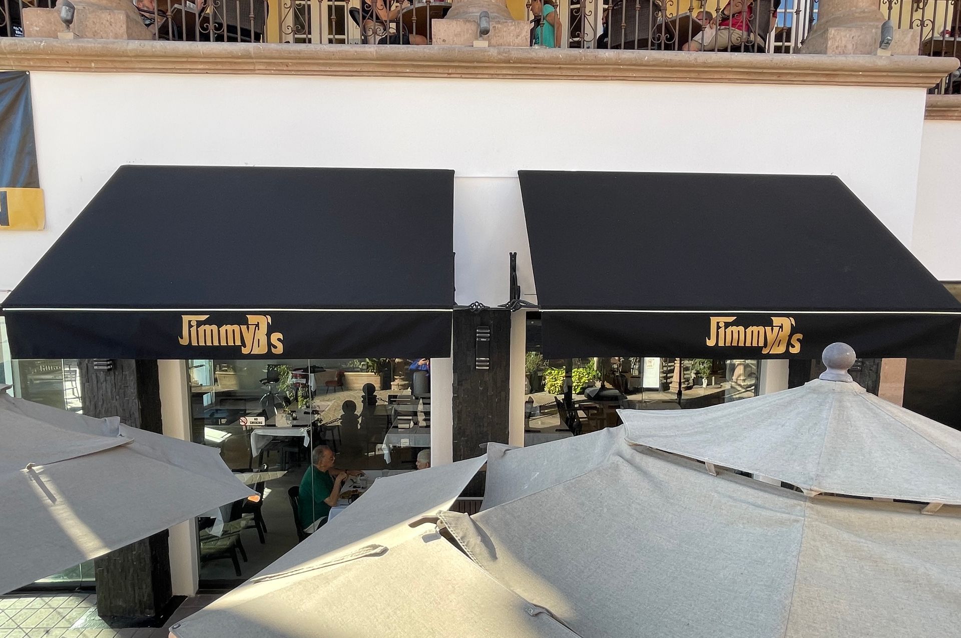 A restaurant storefront with black awnings, labeled 