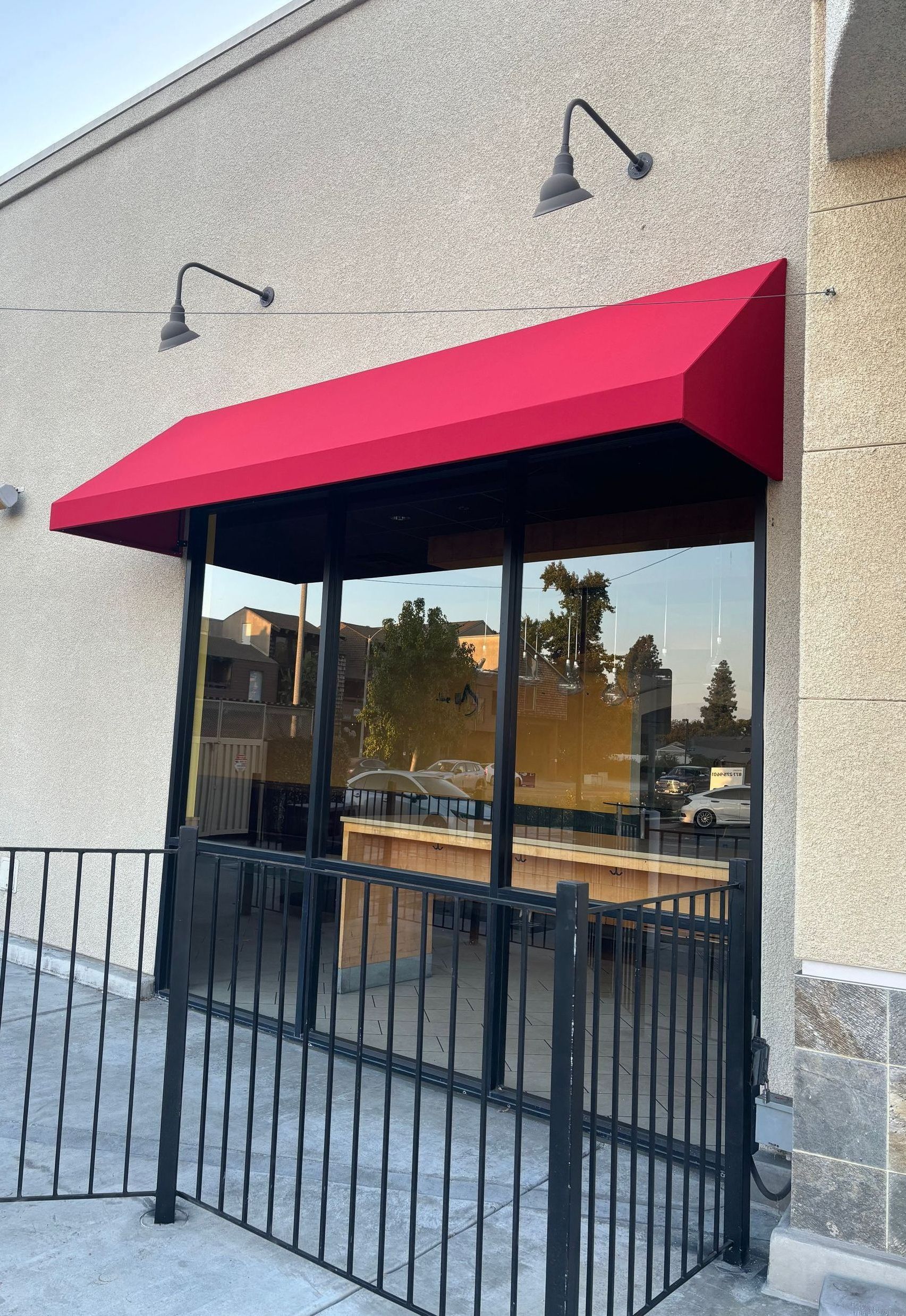 A red awning is on the side of a building.