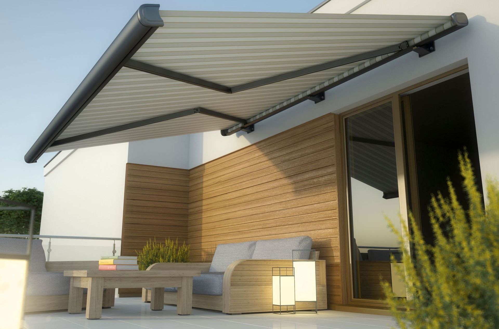 A patio with a couch and table under an awning