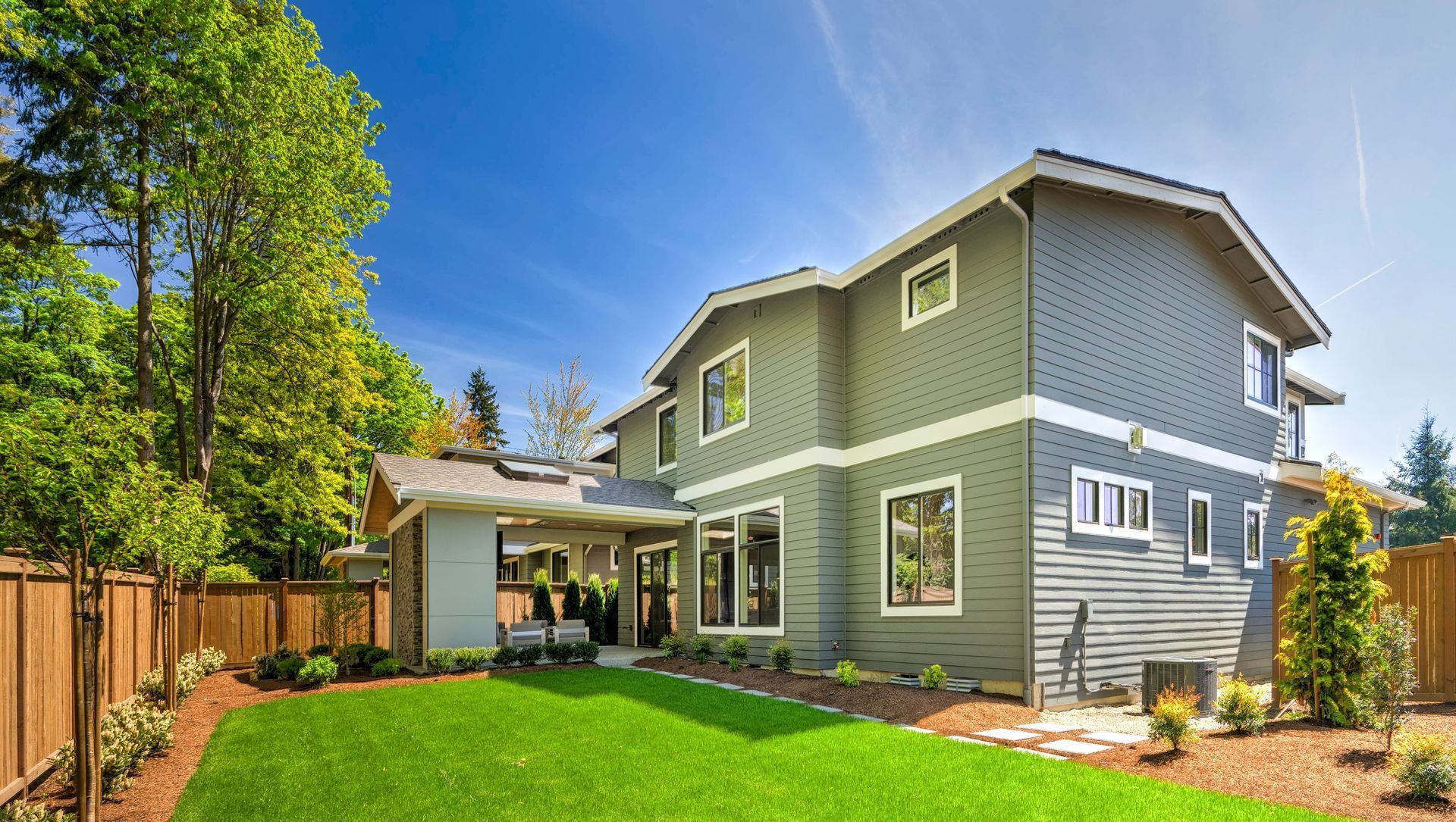 A large house with a lush green lawn in front of it.