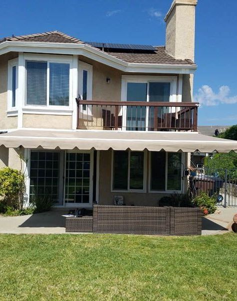 A house with a large awning on the back of it